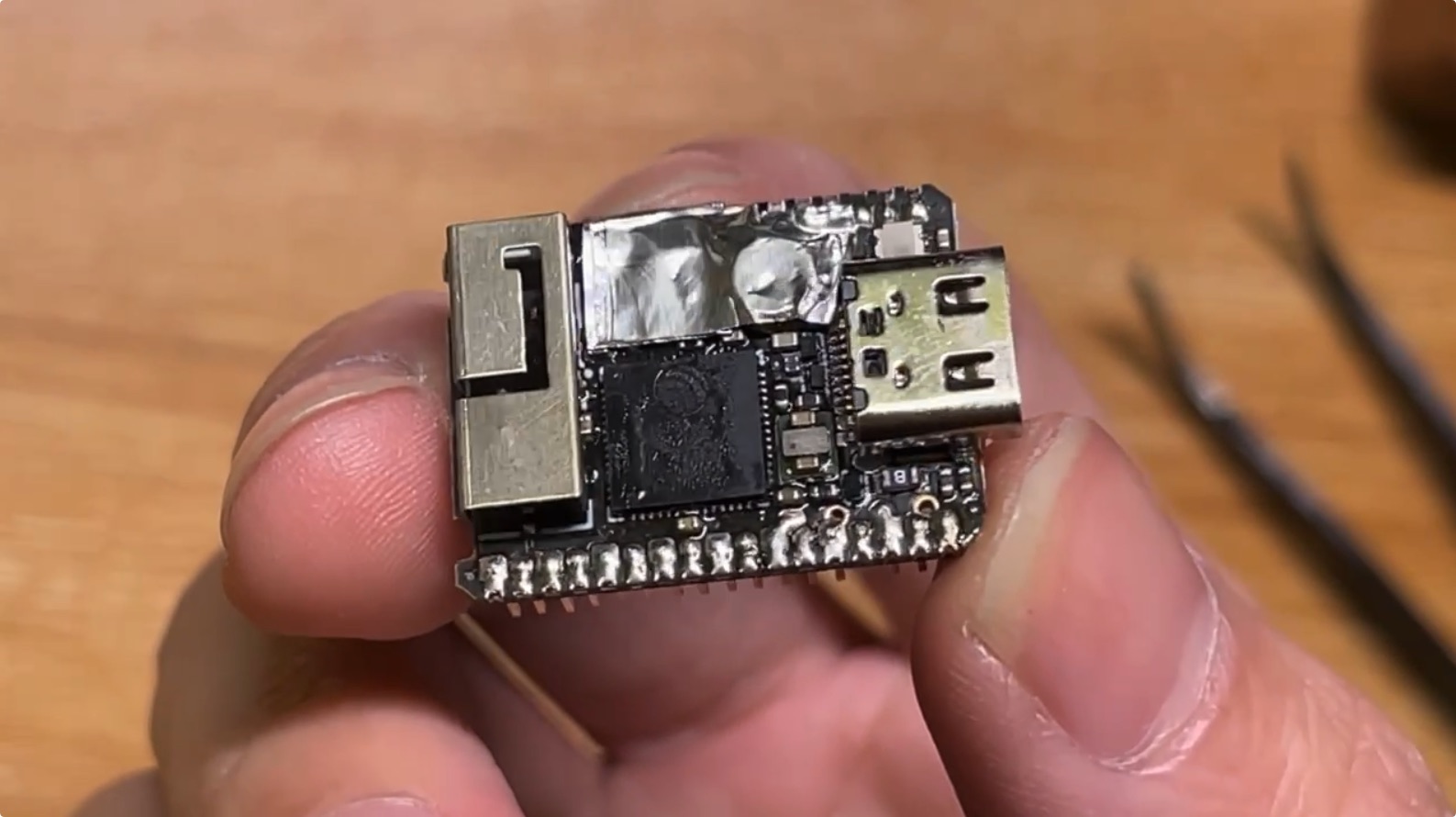 Manual replacement of ESP32-S3 chip on M5Stack Cardputer using heat gun and aluminum foil tape